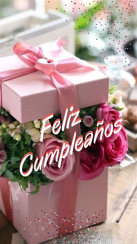 A Pink Box That Has Some Flowers In It And The Words Feliz Cumpleanos