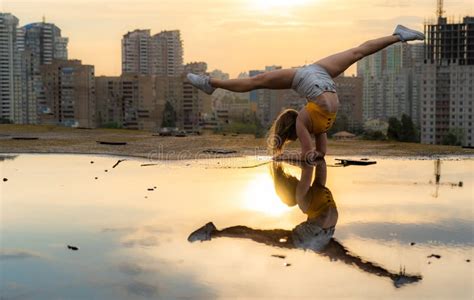 Flexible Female Gymnast Doing Handstand And Calisthenic With Reflection