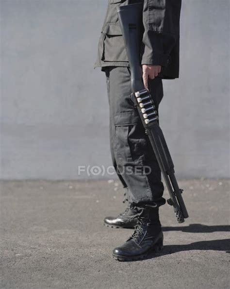 Man Holding High Powered Shotgun Security Rifle Stock Photo