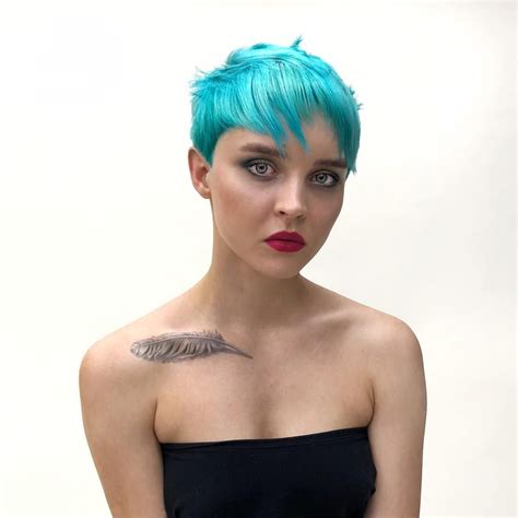 eccentric choppy pixie with messy texture and bright turquoise blue hair color the latest