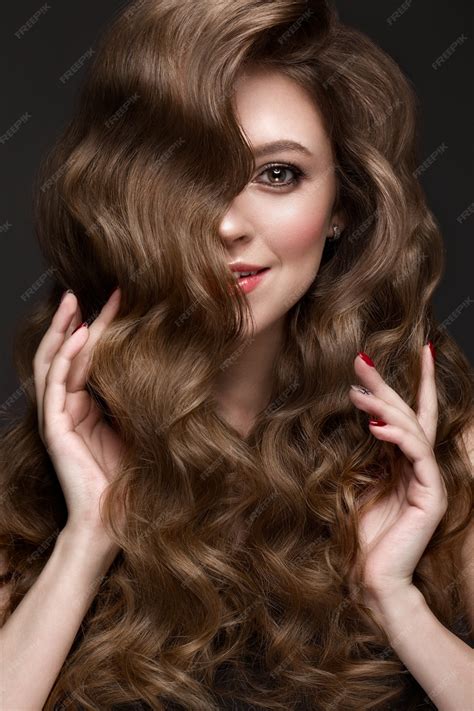 Premium Photo Beautiful Brownhaired Girl With A Perfectly Curls Hair And Classic Makeup