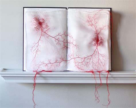 Fabric Books Decoratively Embroidered With Red Thread Tendrils That