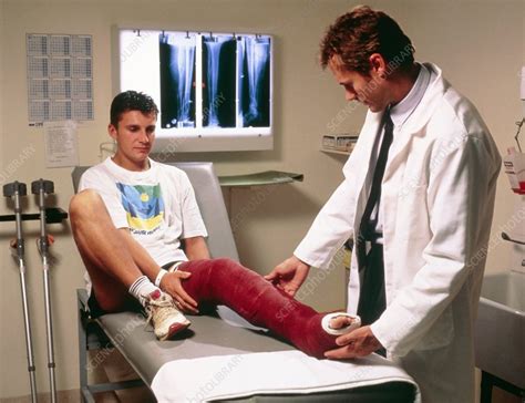 Doctor Examining Full Leg Cast Of Patient Stock Image M3300331