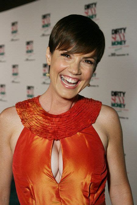 A Woman In An Orange Dress Smiling At The Camera