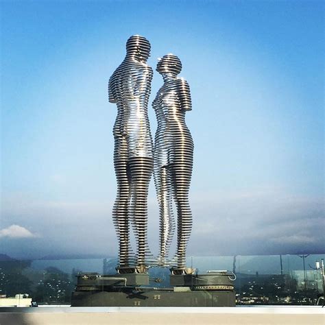 Moving Statues Of A Man And Woman Pass Through Each Other Daily