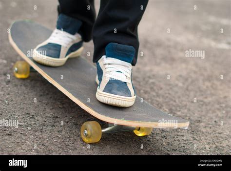Skateboarder Feet In Sneakers On A Skateboard Stock Photo Alamy