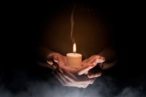 Hands Holding Candle Premium Photo