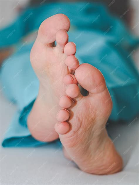 Premium Photo Clean And Crossed Feet Of A Young Caucasian Male