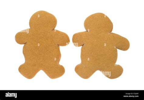 Two Unfrosted Gingerbread Men Christmas Cookies Side By Side On A White
