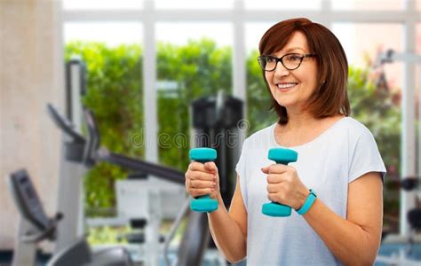 Happy Old Woman With Dumbbells Exercising In Gym Stock Photo Image Of