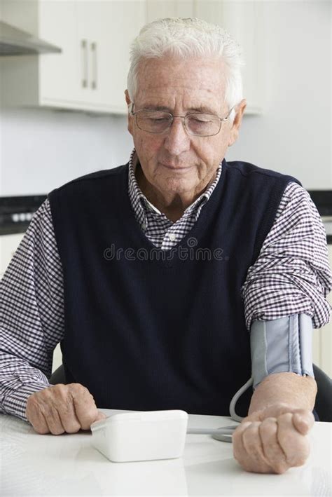 Senior Man Measuring Blood Pressure At Home Stock Photo Image Of