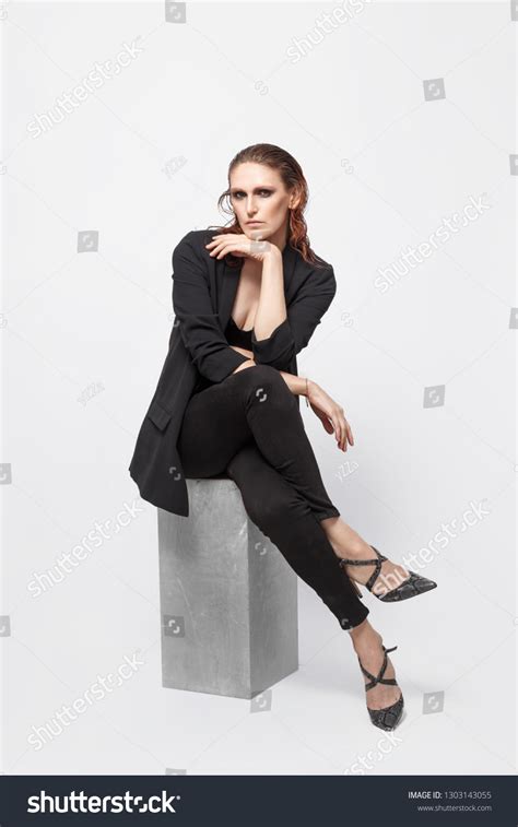 Beautiful Female Professional Fashion Model Sitting Stock Photo