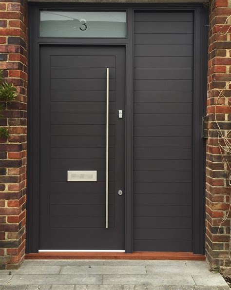 Stylish Front Door With A Bright Modern Finish And Brass Door