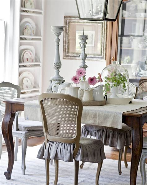 This dining room offers a white dining set and a fancy crystal chandelier that hung from the wood beam ceiling. Frilly Shabby Chic Dining Room with caned back chairs ...