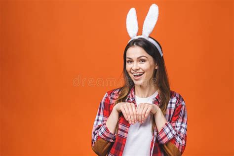 Beautiful Young Brunette Woman In Bunny Ears Looking At Camera While