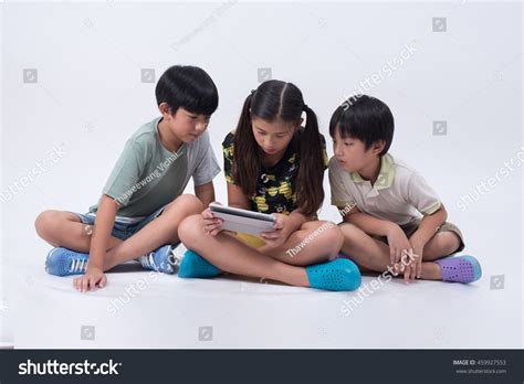 Asian Kids Playing Tablet Phone Looking Stock Photo 459927553