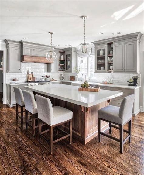 21 A Modern Farmhouse Kitchen With A Large Kitchen Island Of Wood And A