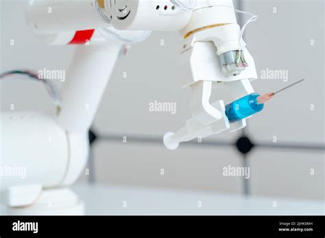 Robot hand with a medical syringe. Future medicine concept using robots