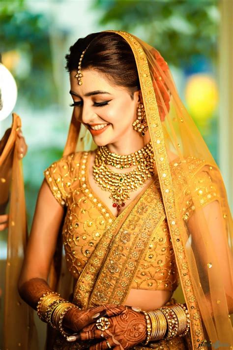 A Shy Bride In A Golden Lehenga On Her Wedding Day Bridal Outfits