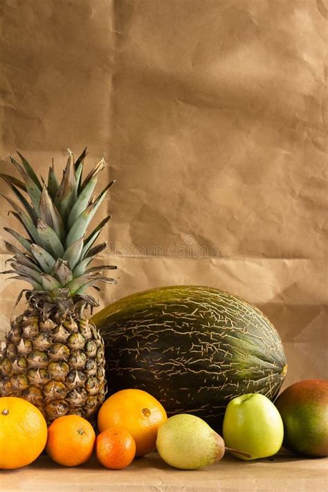 Still Life Of Tropical Fruits On A Light Brown Background Stock Photo