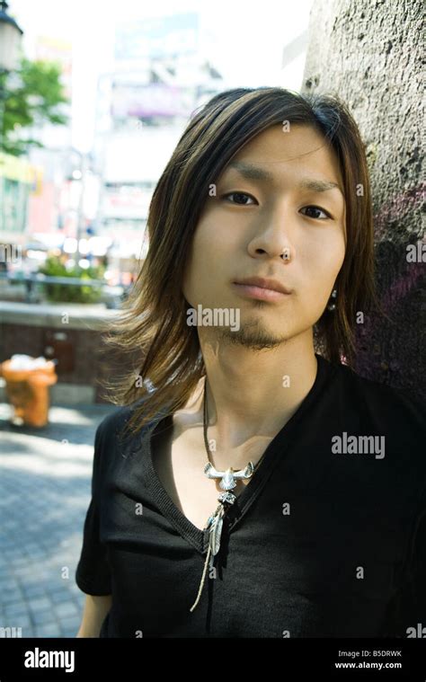 Young Man Leaning Against Tree Portrait Stock Photo Alamy