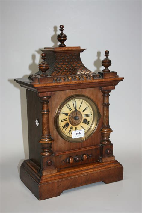 A Late 19th Century German Walnut Cased Mantel Clock With Eight Day Movement Striking On A Gong The