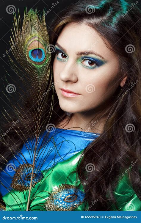 Close Up Beauty Portrait Of Beautiful Girl With Peacock Feather