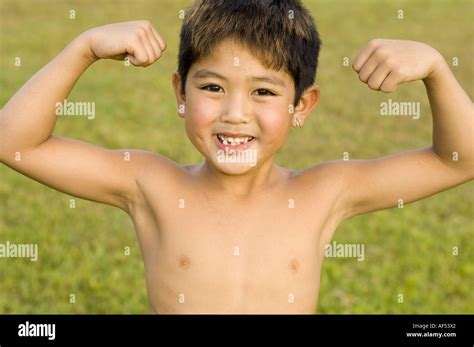 Portrait Of A Boy Flexing His Muscles Stock Photo Alamy