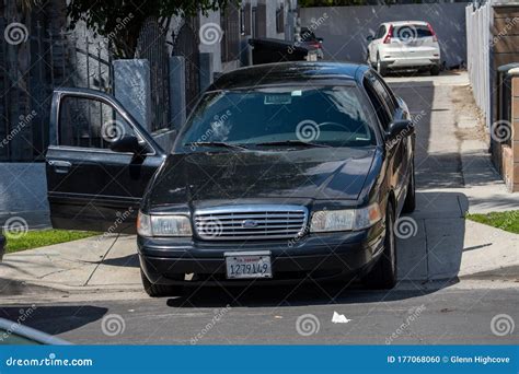 A Ford Crown Victoria Unmarked Police Car Parked With Its Passenger
