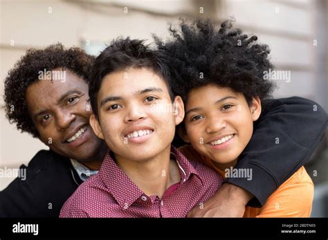 African American Father Hugging His Two Sons Stock Photo Alamy