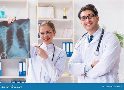 Two Doctors Examining X Ray Images Of Patient For Diagnosis Stock Photo