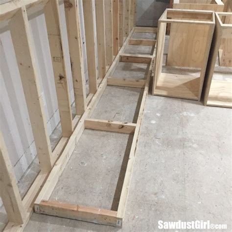 This makes room for adjustments when installing them next to one another. Building a wall behind the craft room cabinets - Sawdust Girl®