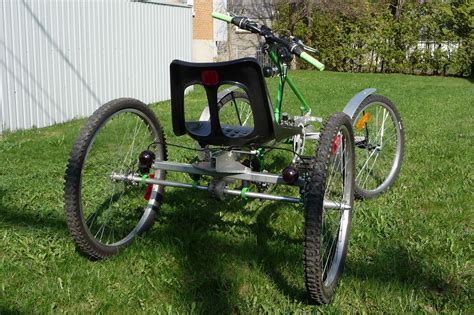 A Bike That Is Sitting In The Grass With Its Seat On Its Back