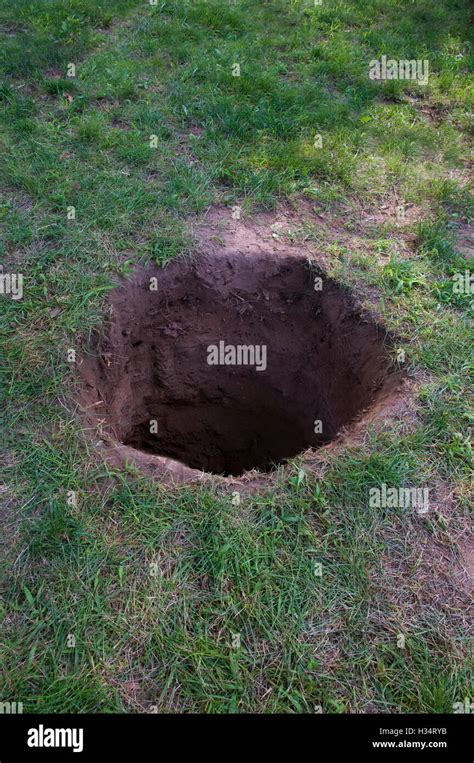 Deep Dirt Hole In Ground Or Lawn Stock Photo Alamy