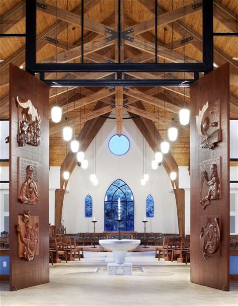 The Inside Of A Church With Wooden Doors