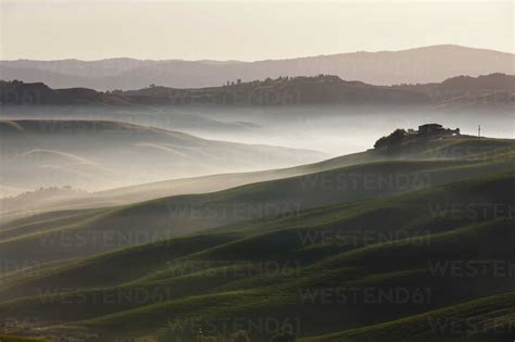 Italy Tuscany Crete View Of Farm With Fog At Hilly Landscape Stock Photo
