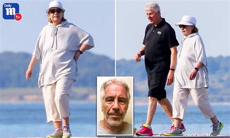 Laid Back Bill And Hillary Clinton Take Causal Stroll On Beach In The