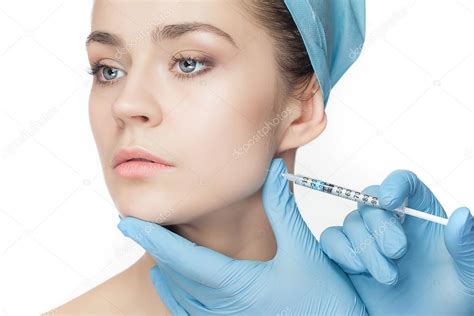 Attractive Woman At Plastic Surgery With Syringe In Her Face Stock