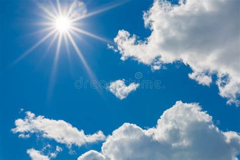 Bright Midday Sun And Puffy Clouds In Blue Sky Stock Photo Image Of