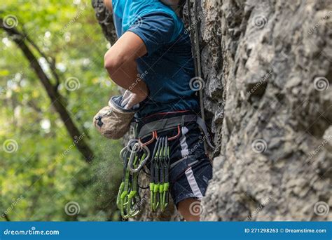 Male Climber Reaching For Magnesium While Hanging On A Rope In The