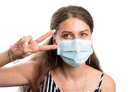 Woman Wearing Disposable Mask Making Peace Or Victory Sign Stock Photo