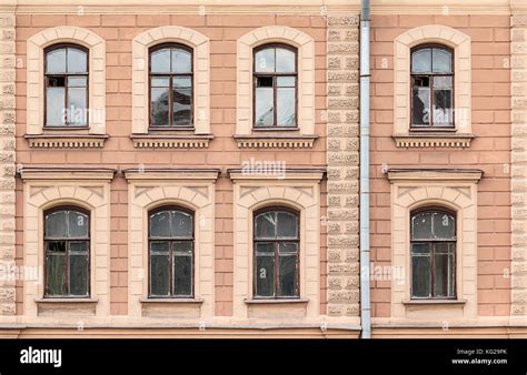 Several Windows In A Row On Facade Of Urban Apartment Building Front