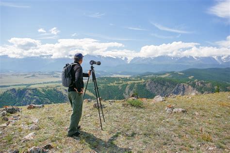 Travel Photographer Man Taking Nature Photo Or Video Of Mountain