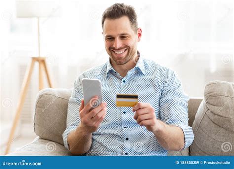 Cheerful Man Holding Smartphone And Credit Card Stock Image Image Of