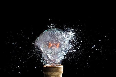 Premium Photo Explosion Of A Glass Bulb On Black High Speed Photography