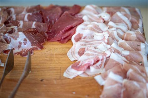 Appetizer Of Cold Cuts And Mixed Cold Cuts On A Wooden Chopping Board