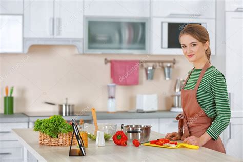 Young Woman Cooking In Kitchen Stock Photo By ©belchonock 101635032