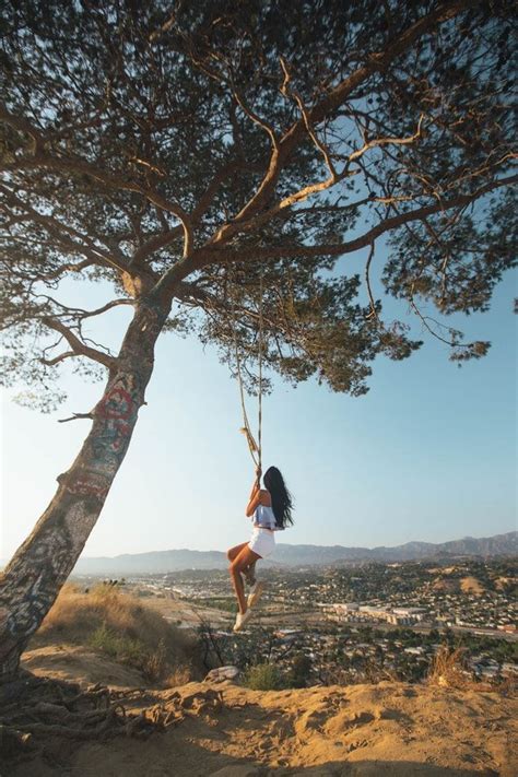 Woman Swinging On Tree