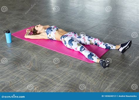 Fit Young Female Lying On Exercise Mat In Gym Healthy Woman Taking