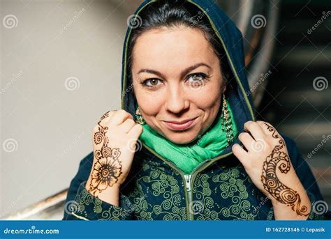 Beautiful Woman Of Oriental Appearance With Makeup On Her Face And Henna Pattern On Her Hands
